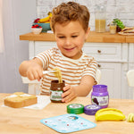 boy getting play sand peanut butter out of jar