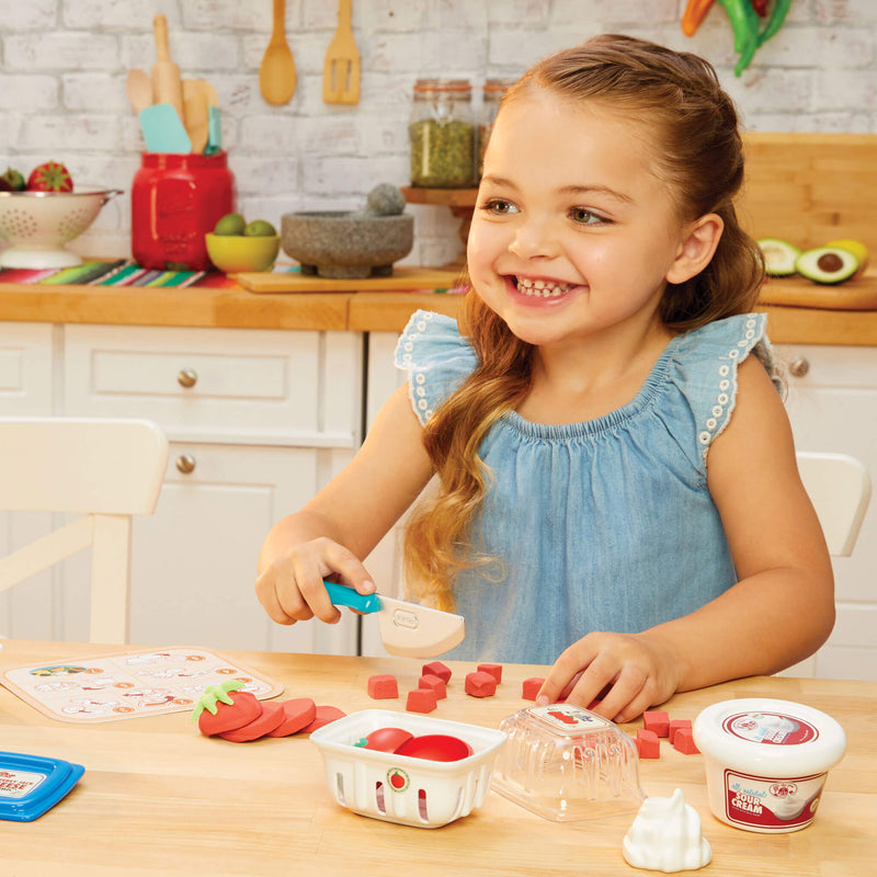 girl cutting play tomato