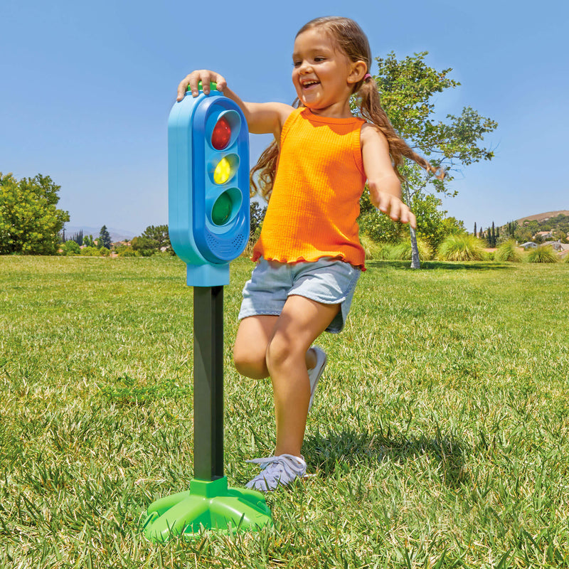 Girl pressing green button on top of game 