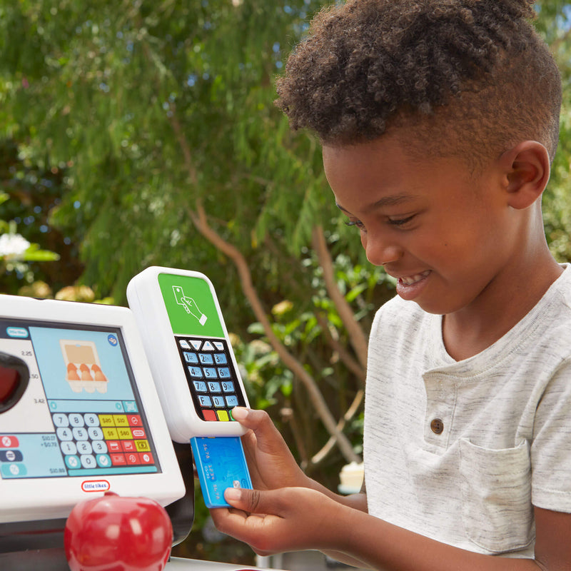 Boy using the toy credit card scanner