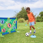 Boy kicking ball into net