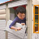 child adding panels to house