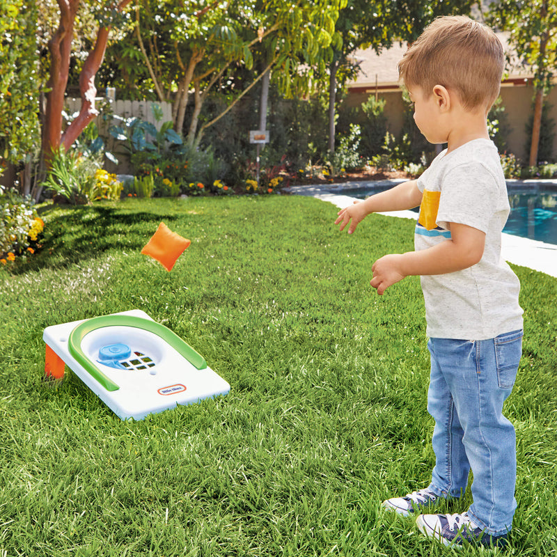 boy tossing bean bag