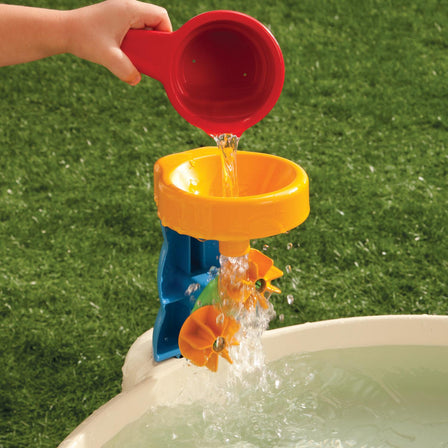 Spiralin' Seas Waterpark - 
Fill the cup with water and pour it into the funnel to power twin water wheels.