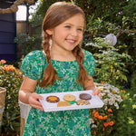 Girl holding Tray of cookies